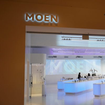 Moen Backlit Signage With Staff in Background
