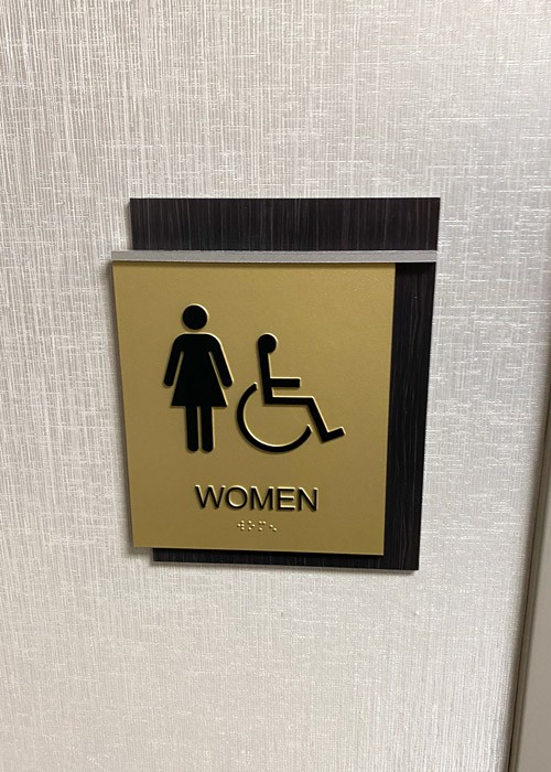 Restroom Sign Installed With Braille at Women's Washroom